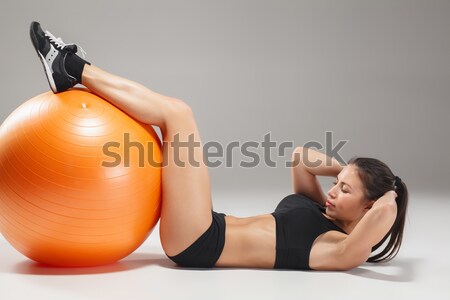 Stock photo: The young, beautiful, sports girl doing exercises on a fitball 