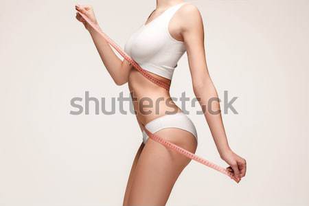 Woman holding meter measuring perfect shape of her beautiful body  Stock photo © master1305
