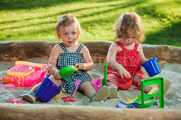 The two little baby girls playing toys in sand Stock photo © master1305