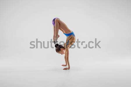 Young beautiful dancer in beige swimwear dancing on lilac background Stock photo © master1305