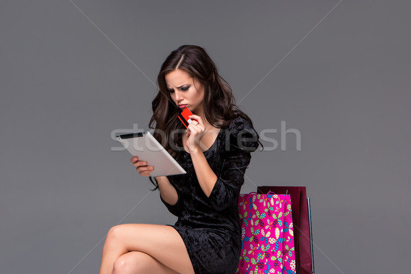 Beautiful young girl paying by credit card for shopping  Stock photo © master1305