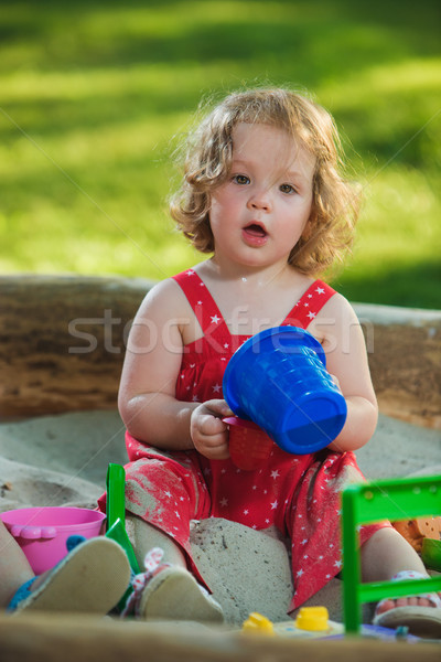 The little baby girl playing toys in sand Stock photo © master1305
