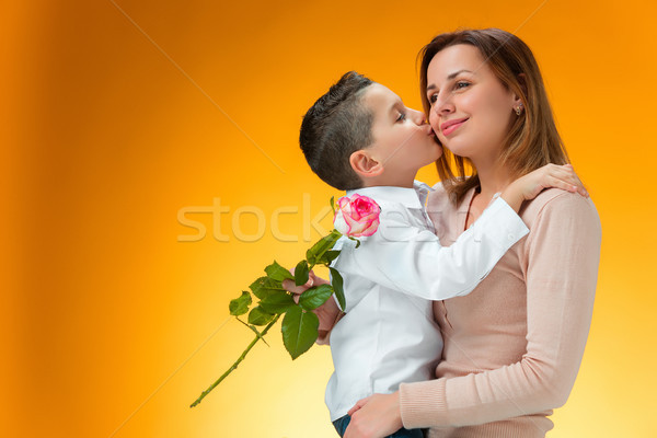 Young kid giving red rose to his mom Stock photo © master1305