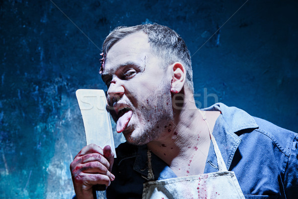 Bloody Halloween theme: crazy killer as butcher with a knife Stock photo © master1305