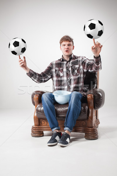 The portrait of fan with balls, holding dish on gray background Stock photo © master1305