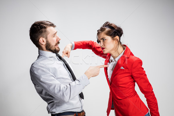 The angry business man and woman conflicting on a gray background Stock photo © master1305