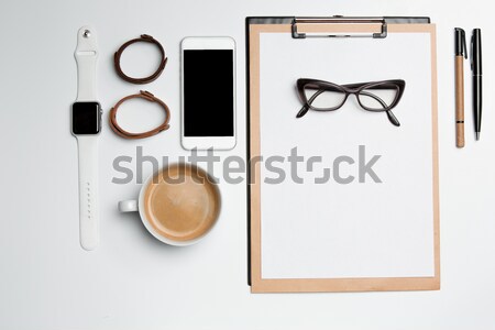 Stock photo: Office desk table with cup, supplies, phone on white