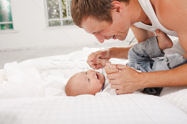 young father with his nine months old son on the bed at home Stock photo © master1305