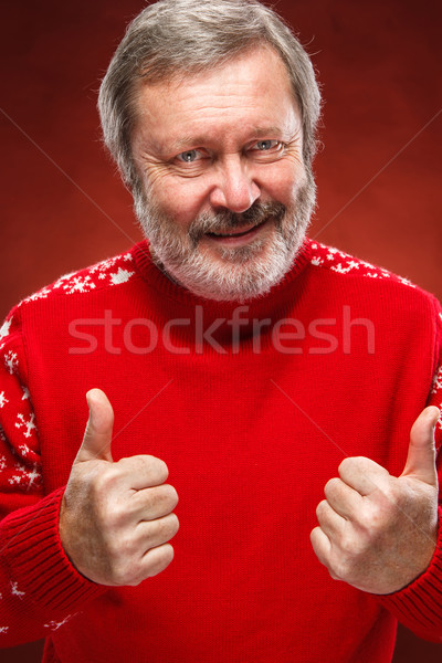 Elderly man showing ok sigh on a red background Stock photo © master1305