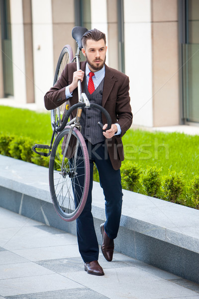 Handsome businessman carrying his bicycle Stock photo © master1305