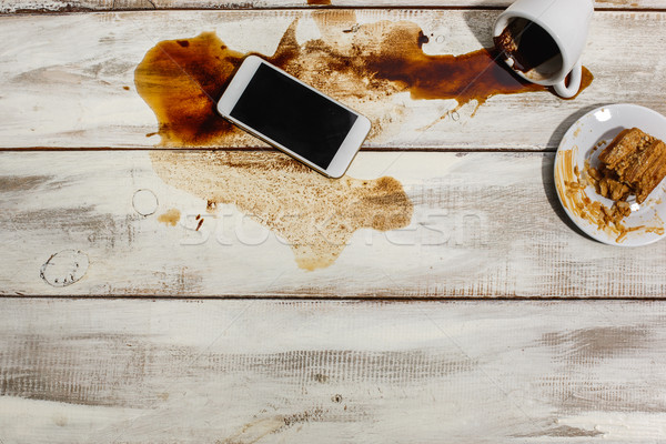 Cup of coffee spilled on wooden table Stock photo © master1305