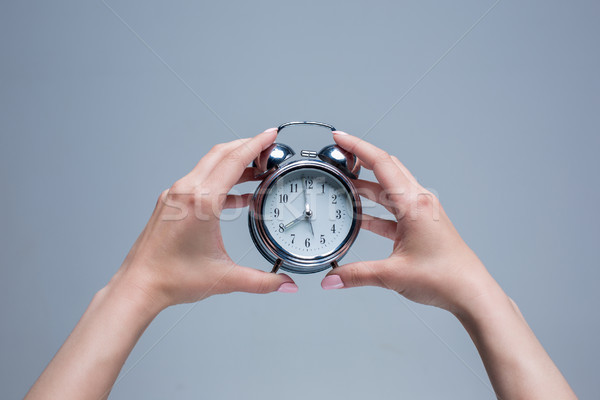 The female hands and old style alarm clock  Stock photo © master1305