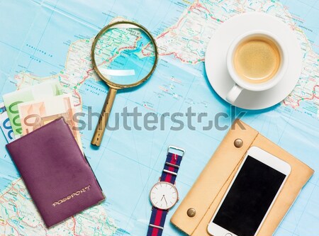 Stock photo: Preparation for travel concept - map, magnifying glass, cup of coffee, notepad, phone