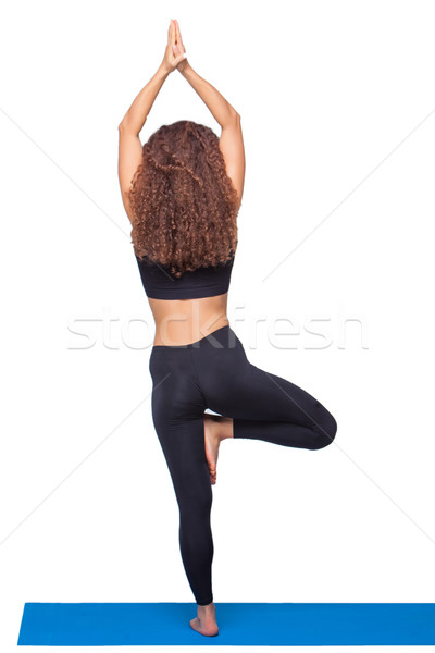 Studio shot of a young fit woman doing yoga exercises. Stock photo © master1305