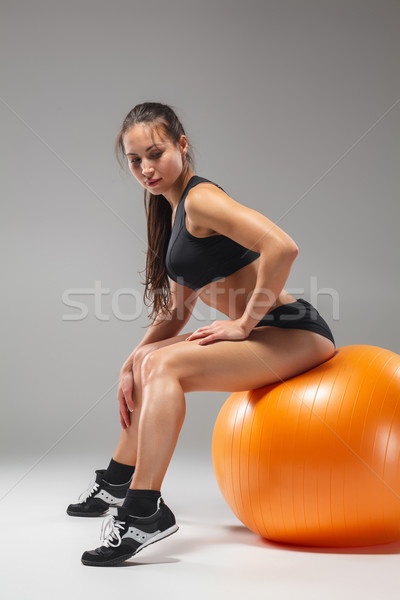 Stock photo: The young, beautiful, sports girl doing exercises on a fitball 