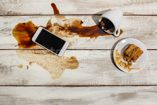 Cup of coffee spilled on wooden table Stock photo © master1305