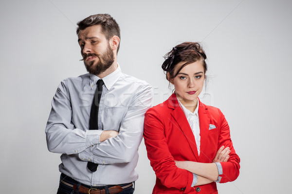 The sad business man and woman conflicting on a gray background Stock photo © master1305