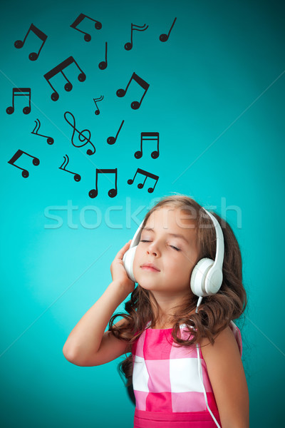 Cute petite fille orange écouter de la musique casque [[stock_photo]] © master1305