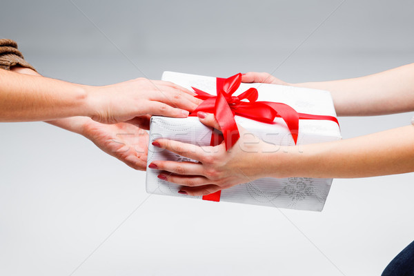 Hands giving and receiving a present Stock photo © master1305