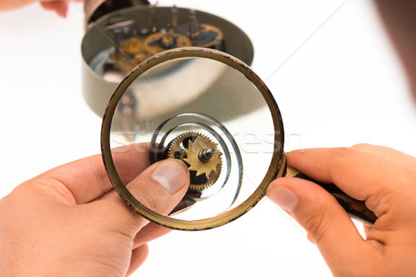 The male hand with magnifier and clockwork Stock photo © master1305