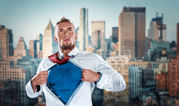 Stock photo: businessman acting like  super hero and tearing his shirt off