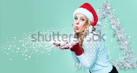 Stock photo: Beautiful young woman in Santa Claus clothes with snowflakes