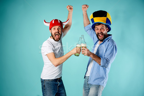 Stock photo: The two football fans over blue
