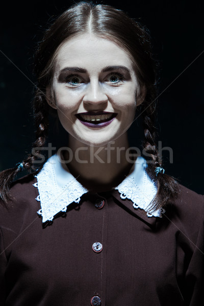 Portrait of a young smiling girl in school uniform as killer woman Stock photo © master1305