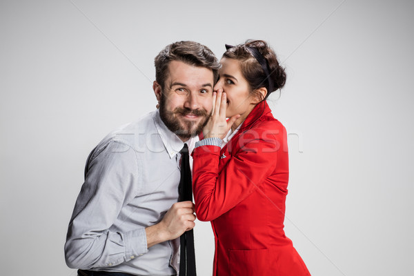Young man telling gossips to his woman colleague at the office Stock photo © master1305