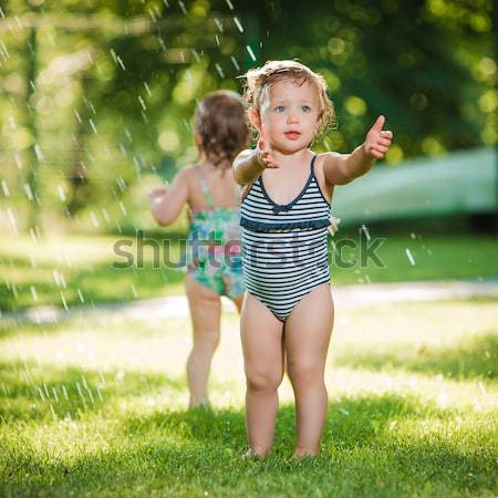 Kicsi kislány játszik kert locsoló nyár Stock fotó © master1305