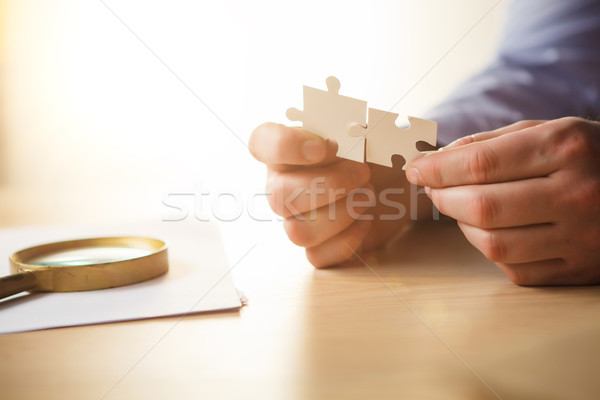 Stock photo: Building a business success. The hands with puzzles