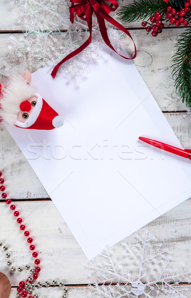 Stock photo: The blank sheet of paper on the wooden table with a pen 