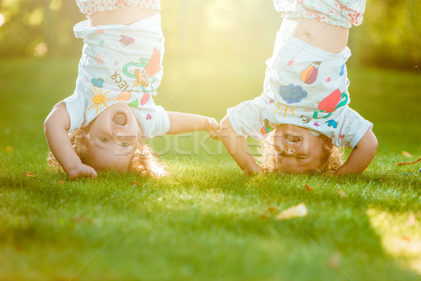 Kettő kicsi lánycsecsemők akasztás fejjel lefelé öreg Stock fotó © master1305