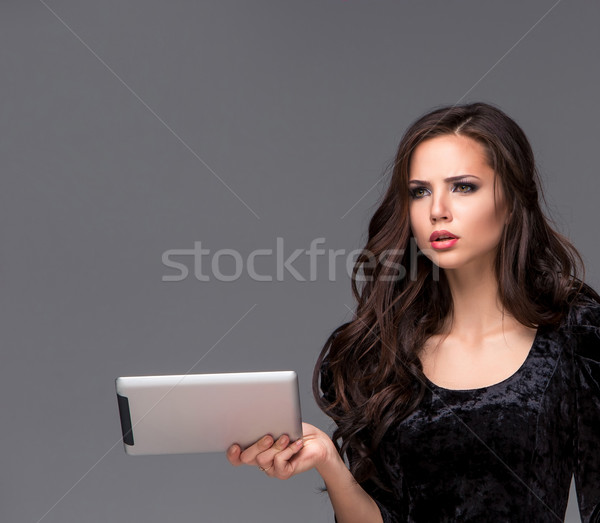 Sad woman using a tablet Stock photo © master1305