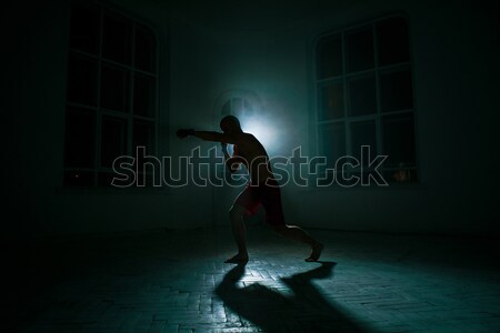 The young man kickboxing on black background Stock photo © master1305