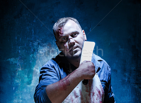 Bloody Halloween theme: crazy killer as butcher with a knife Stock photo © master1305