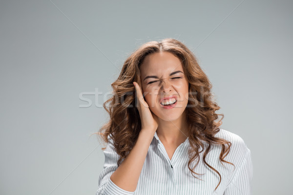 The young woman with earache over gray Stock photo © master1305