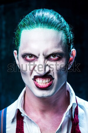 The scary clown and electric drill on dack background. Halloween concept Stock photo © master1305
