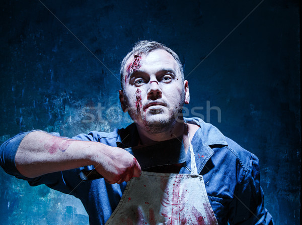 Bloody Halloween theme: crazy killer as butcher with a knife Stock photo © master1305
