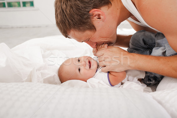 young father with his nine months old son on the bed at home Stock photo © master1305