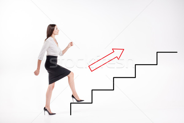 Young businesswoman walking up on stairs Stock photo © master1305