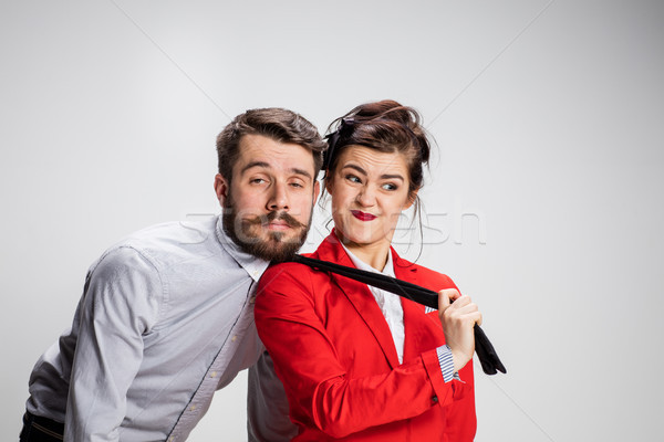 The business man and woman cooperating on a gray background Stock photo © master1305