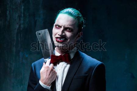 The scary clown holding a knife on dack. Halloween concept Stock photo © master1305