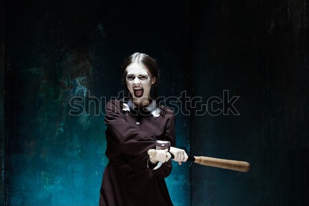 Stock photo: Bloody Halloween theme: crazy killer as butcher with an ax