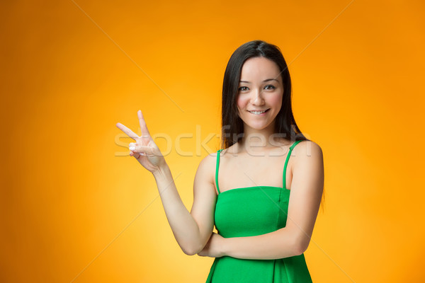 The happy Chinese girl on yellow background Stock photo © master1305