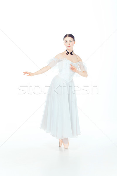 Ballerina in white dress posing on pointe shoes, studio background. Stock photo © master1305
