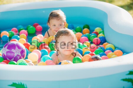Kettő kicsi lánycsecsemők játszik játékok felfújható Stock fotó © master1305