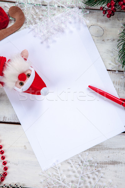 Stock photo: The blank sheet of paper on the wooden table with a pen 