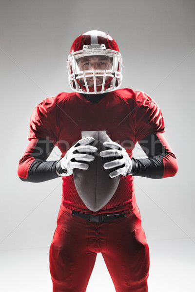 American football player posing with ball on white background Stock photo © master1305