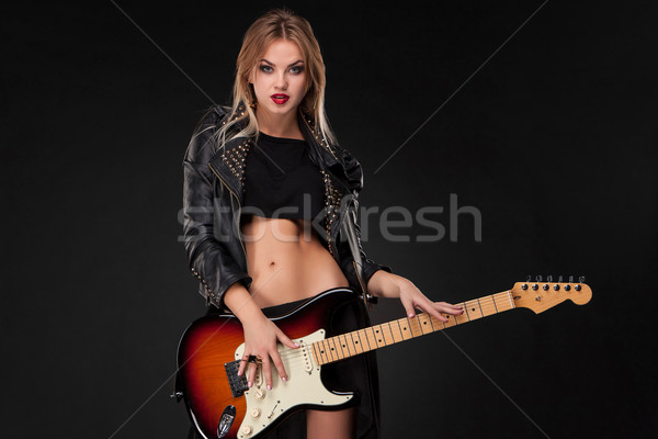 Stock photo: Beautiful girl playing guitar